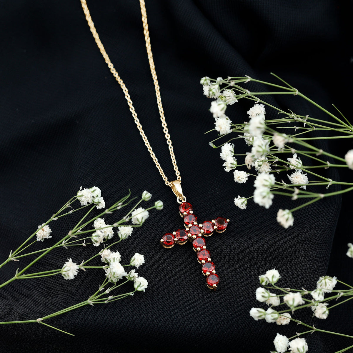Genuine garnet cross pendant necklace by Rosec Jewels featuring a red garnet gemstone on a silver chain.