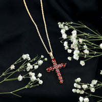 Genuine garnet cross pendant necklace by Rosec Jewels featuring a red garnet gemstone on a silver chain.