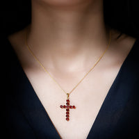 Genuine garnet cross pendant necklace with silver chain from Rosec Jewels, showcasing a detailed cross design with deep red garnet stones.
