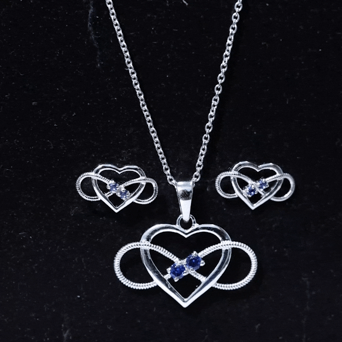 Lab grown blue sapphire infinity heart jewelry set by Rosec Jewels, featuring a necklace and earrings with blue sapphires and gold accents.