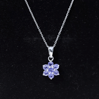 Natural Tanzanite flower cluster pendant necklace featuring vibrant blue stones, elegant design, by Rosec Jewels.