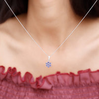Natural Tanzanite flower cluster pendant necklace featuring vibrant blue stones and intricate silver detailing by Rosec Jewels.