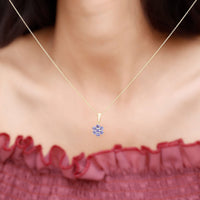 Natural Tanzanite flower cluster pendant necklace featuring vibrant blue stones and intricate sterling silver detailing.