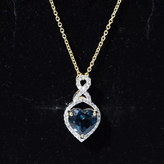 Heart-shaped London Blue Topaz infinity pendant with diamonds from Rosec Jewels, showcasing a vibrant blue gemstone and delicate design.