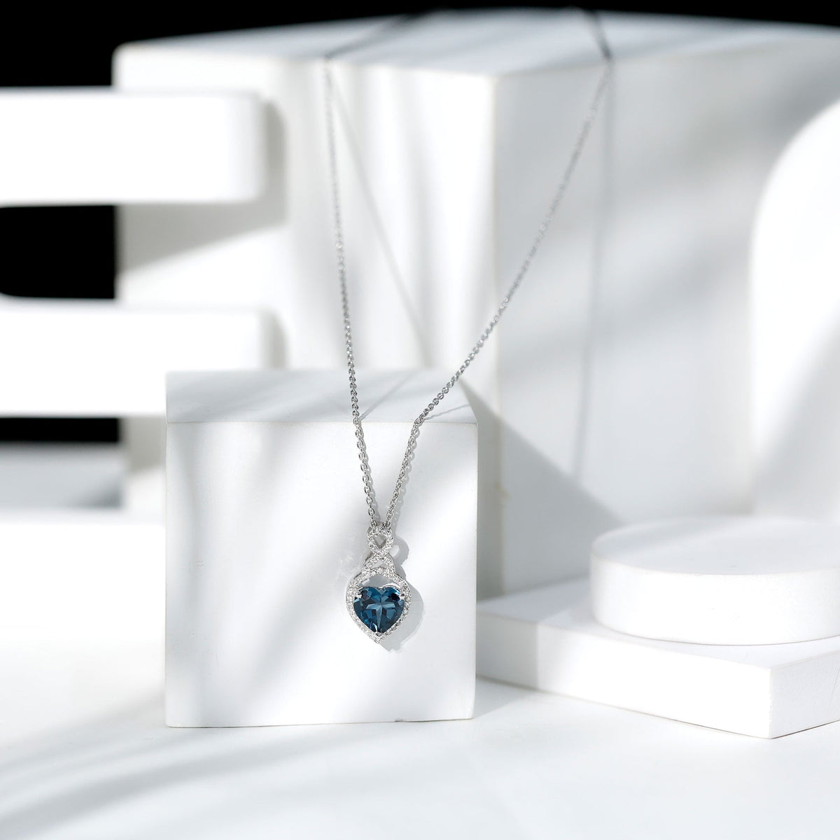 Heart-shaped London Blue Topaz pendant with diamond accents, 2 carats, from Rosec Jewels, showcasing elegant jewelry design.