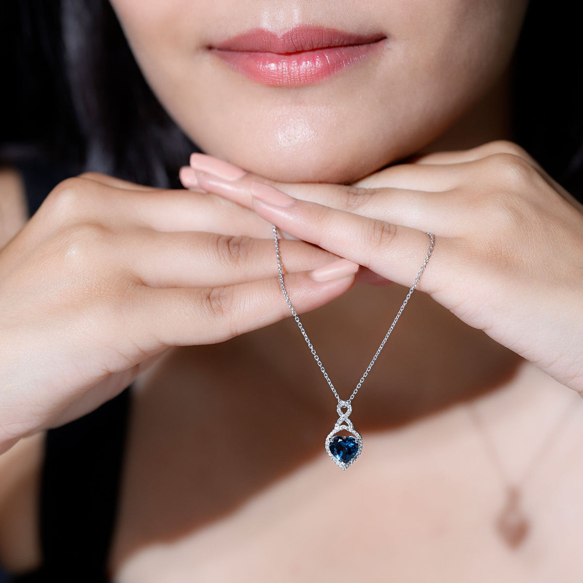 Heart-shaped London Blue Topaz infinity pendant with diamonds, elegant jewelry piece by Rosec Jewels.