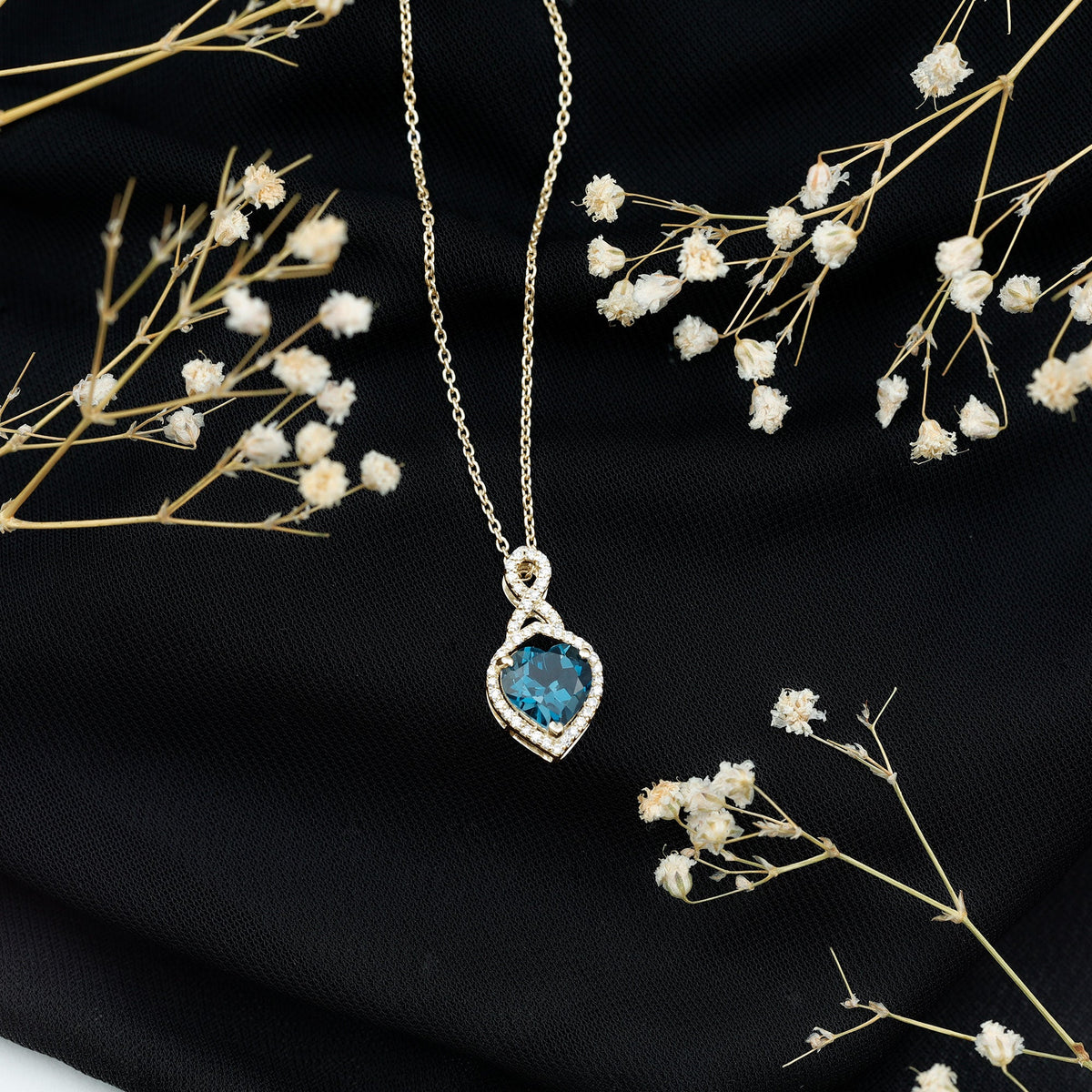 Heart-shaped London Blue Topaz infinity pendant with diamonds from Rosec Jewels, showcasing sparkling gemstones and elegant design.