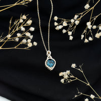 Heart-shaped London Blue Topaz infinity pendant with diamonds from Rosec Jewels, showcasing sparkling gemstones and elegant design.