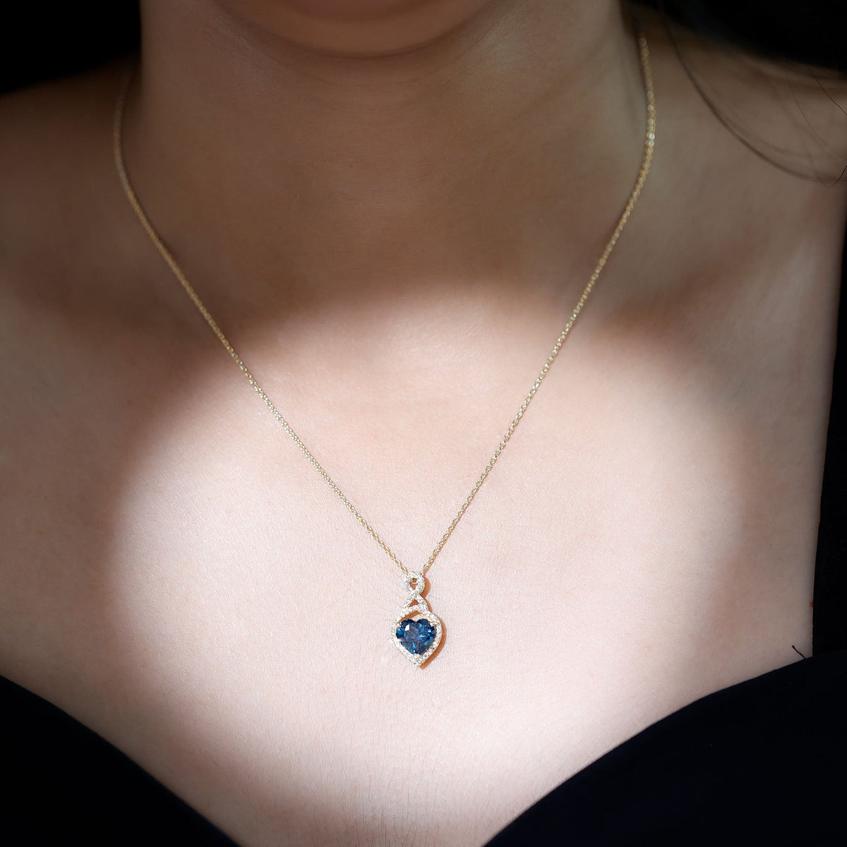 Heart-shaped London Blue Topaz infinity pendant with diamonds by Rosec Jewels, featuring a 2-carat gemstone and elegant design.