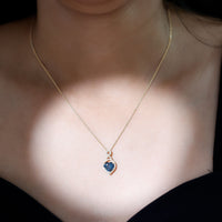 Heart-shaped London Blue Topaz infinity pendant with diamonds by Rosec Jewels, featuring a 2-carat gemstone and elegant design.