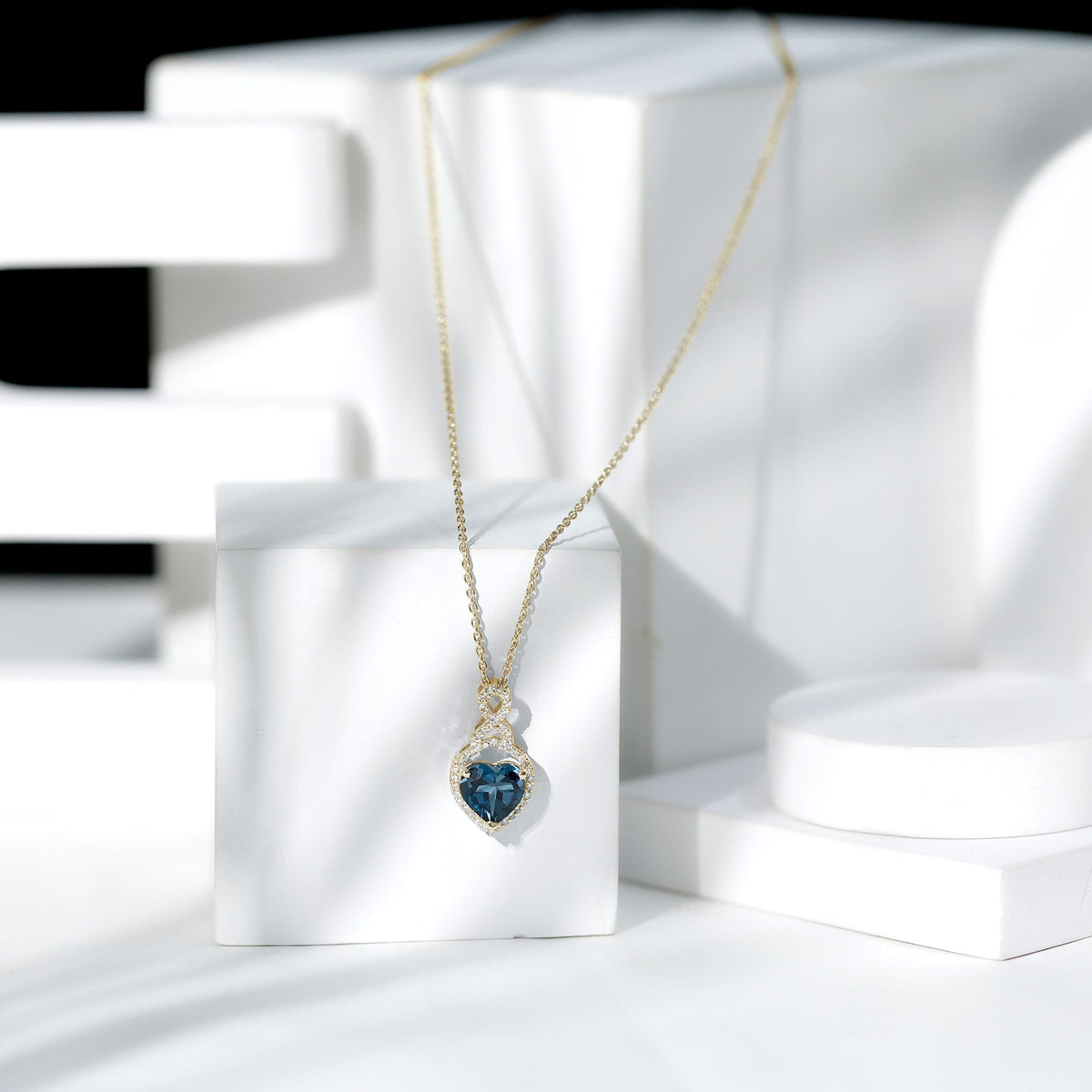 Heart-shaped London Blue Topaz infinity pendant with diamonds, 2 carats, from Rosec Jewels, showcasing elegant jewelry design.