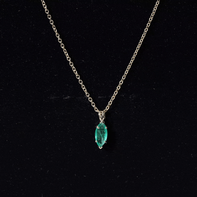 Marquise cut emerald solitaire pendant necklace by Rosec Jewels featuring a green emerald gemstone on a delicate chain.