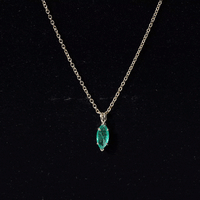 Yellow gold marquise cut emerald solitaire pendant necklace from Rosec Jewels, featuring a prominent green gemstone on a delicate chain.
