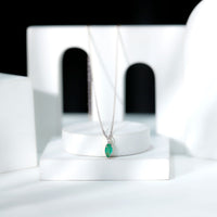 Marquise cut emerald solitaire pendant necklace by Rosec Jewels with a delicate gold chain and elegant gemstone setting.