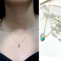 Marquise cut emerald solitaire pendant necklace from Rosec Jewels featuring a prominent green emerald gemstone on a delicate chain.
