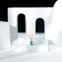 Marquise cut emerald solitaire pendant necklace by Rosec Jewels featuring a single emerald gemstone on a delicate chain.