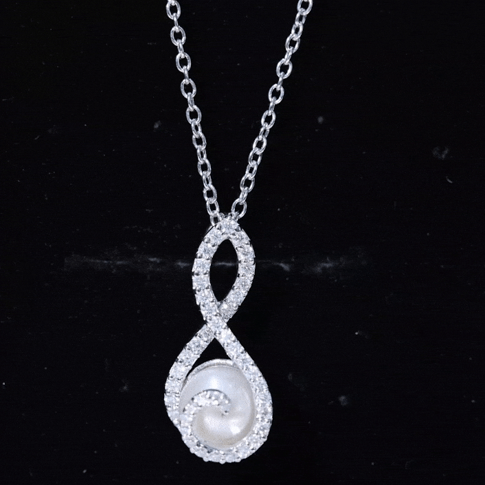 Freshwater white pearl and moissanite infinity pendant in silver, elegant jewelry piece with sparkling stones and polished silver finish.