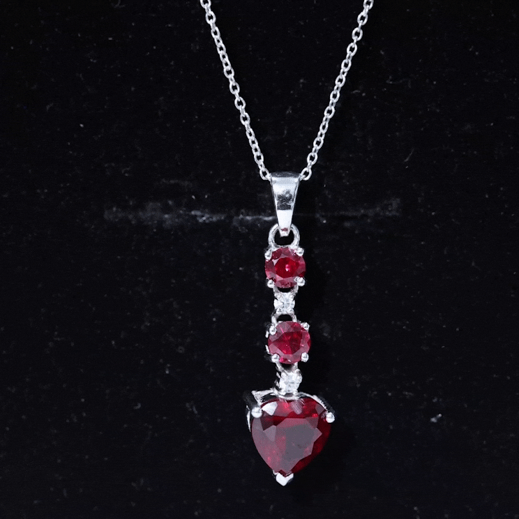 Lab grown 2 carat ruby heart pendant with silver chain from Rosec Jewels, showcasing the sparkling ruby gemstone and elegant silver setting.