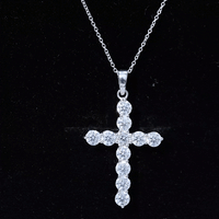 Round moissanite cross pendant necklace by Rosec Jewels with a polished silver chain and sparkling moissanite stones.