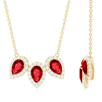 Pear cut lab-created ruby three-stone pendant with moissanite halo, featuring elegant jewelry design from Rosec Jewels.