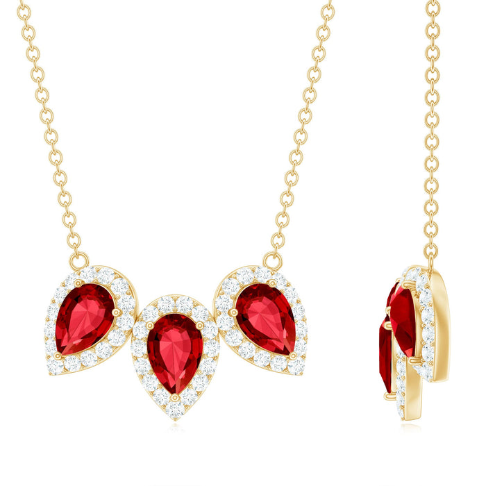 Pear cut lab-created ruby three-stone pendant with moissanite halo, featuring elegant jewelry design from Rosec Jewels.