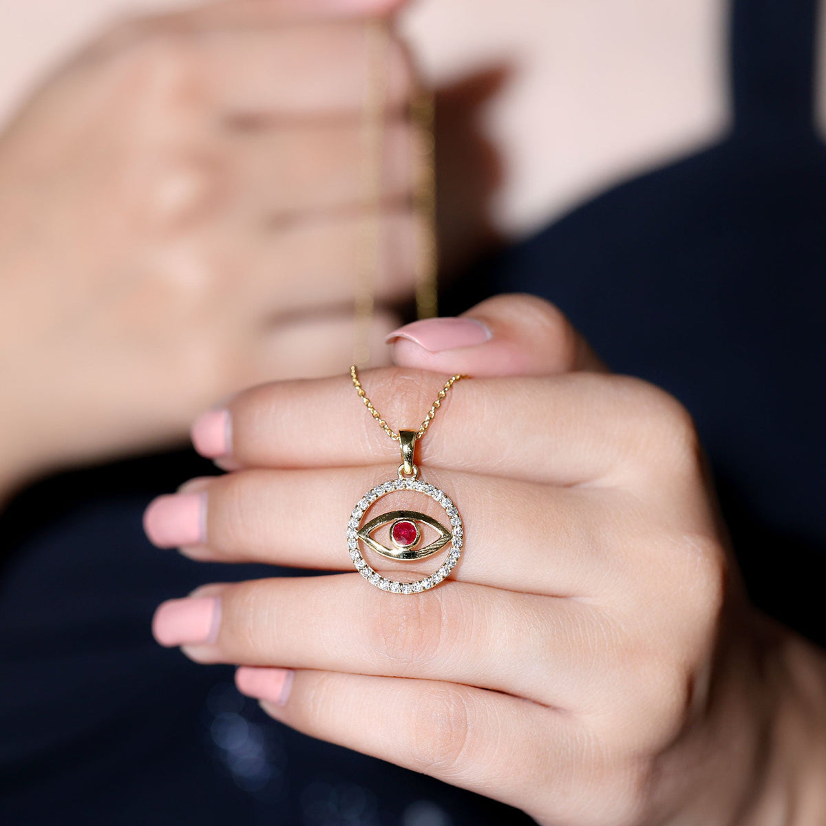 Real ruby and diamond evil eye pendant necklace with intricate design, featuring vibrant red ruby and sparkling diamonds.