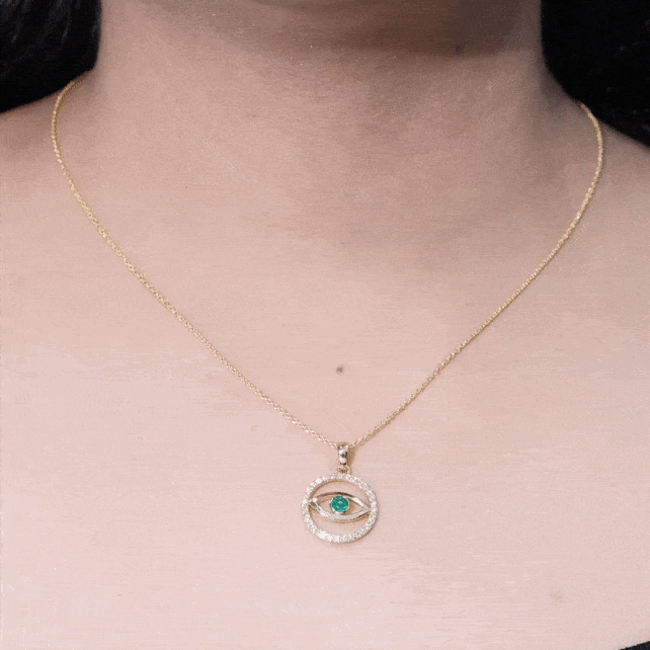 Real emerald and diamond evil eye pendant necklace with gold setting, featuring intricate gemstone detailing from Rosec Jewels.