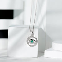 Real emerald and diamond evil eye pendant necklace by Rosec Jewels featuring a vibrant green emerald and sparkling diamonds.