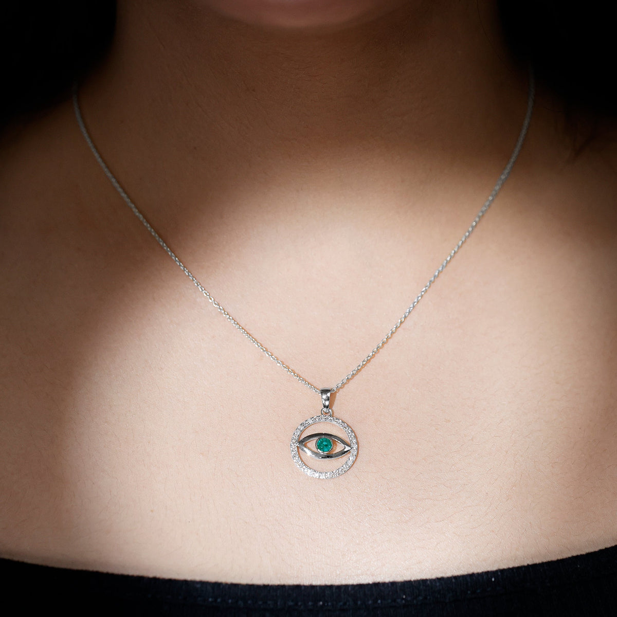Real emerald and diamond evil eye pendant necklace from Rosec Jewels featuring a detailed gold pendant with sparkling gemstones.