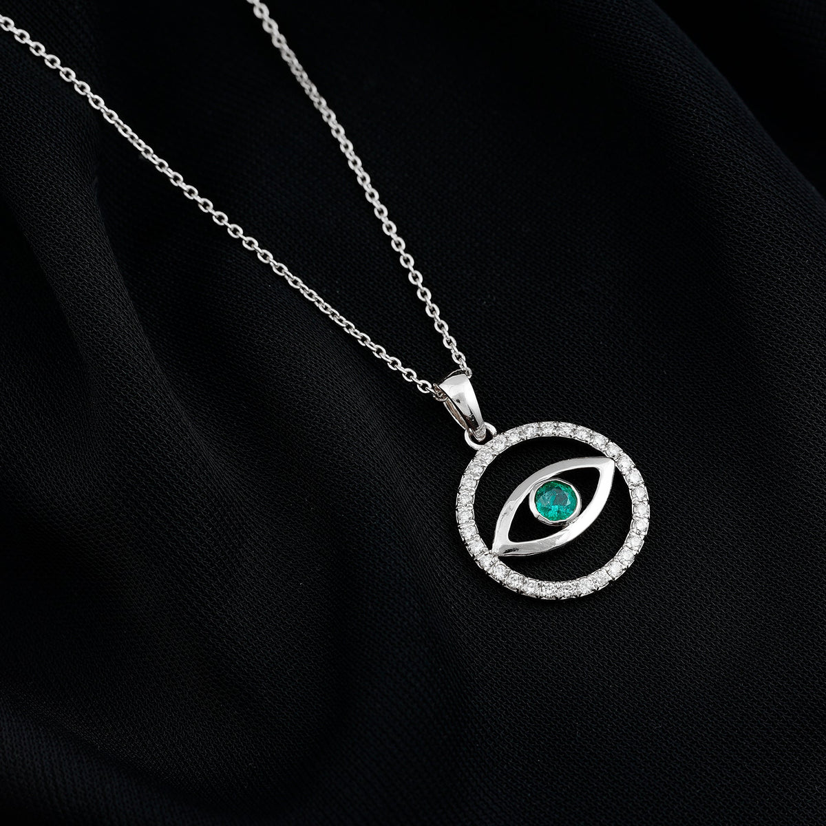 Real emerald and diamond evil eye pendant necklace by Rosec Jewels featuring a vibrant green emerald with sparkling diamonds.