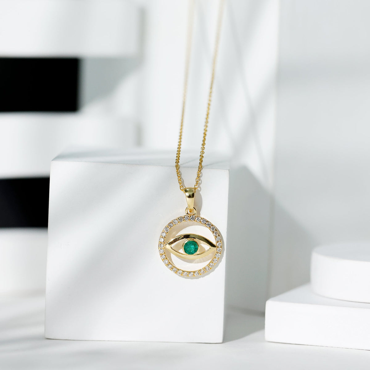 Real emerald and diamond evil eye pendant necklace by Rosec Jewels featuring a vibrant emerald and sparkling diamonds.