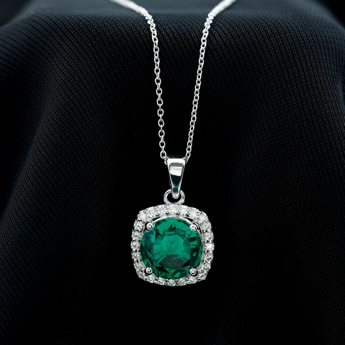 Round cut lab-created emerald and diamond pendant necklace from Rosec Jewels, showcasing elegant design and sparkling gemstones.