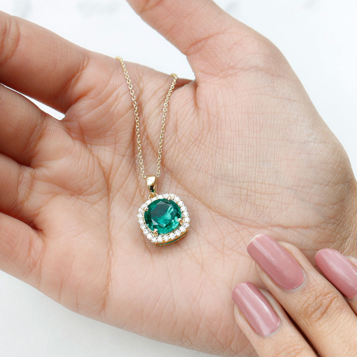 Round cut lab-created emerald and diamond pendant necklace featuring a 3.5 carat center stone, from Rosec Jewels.