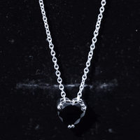 Heart-shaped black spinel solitaire pendant in a double prong setting, featuring a 2-carat black gemstone on a silver chain.