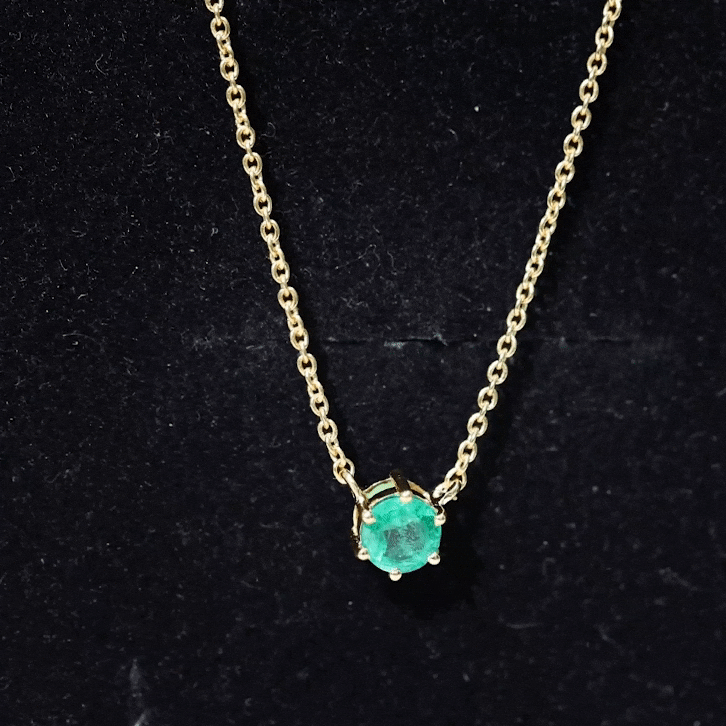 Yellow gold pendant with a 5mm round cut solitaire emerald gemstone set in a 6-prong setting by Rosec Jewels