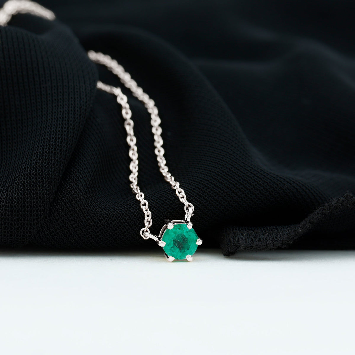 Round cut emerald pendant in 6 prong setting by Rosec Jewels, showcasing a 5mm gemstone on a delicate chain.