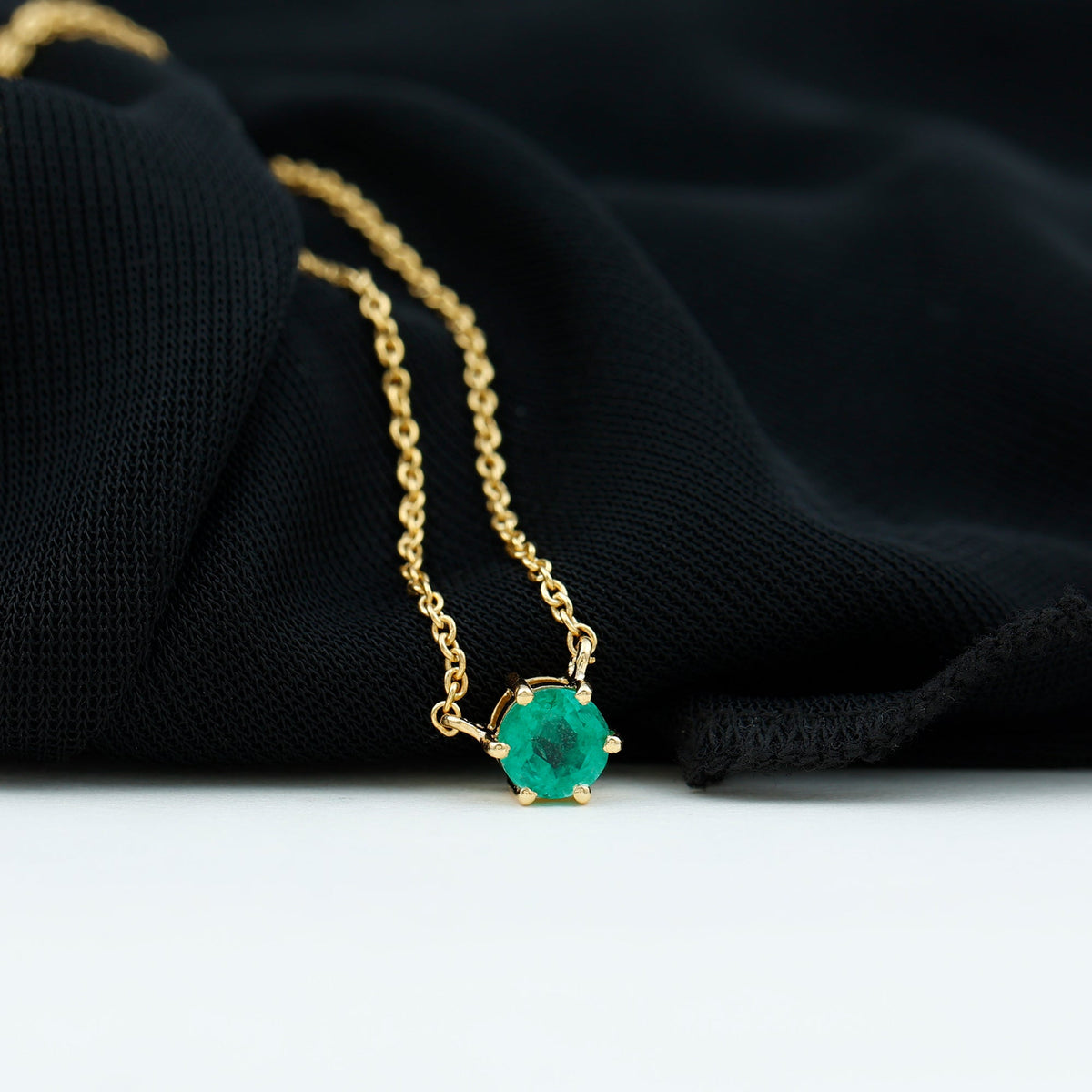 5mm round cut emerald solitaire pendant in a 6 prong setting by Rosec Jewels, showcasing a elegant green gemstone necklace.