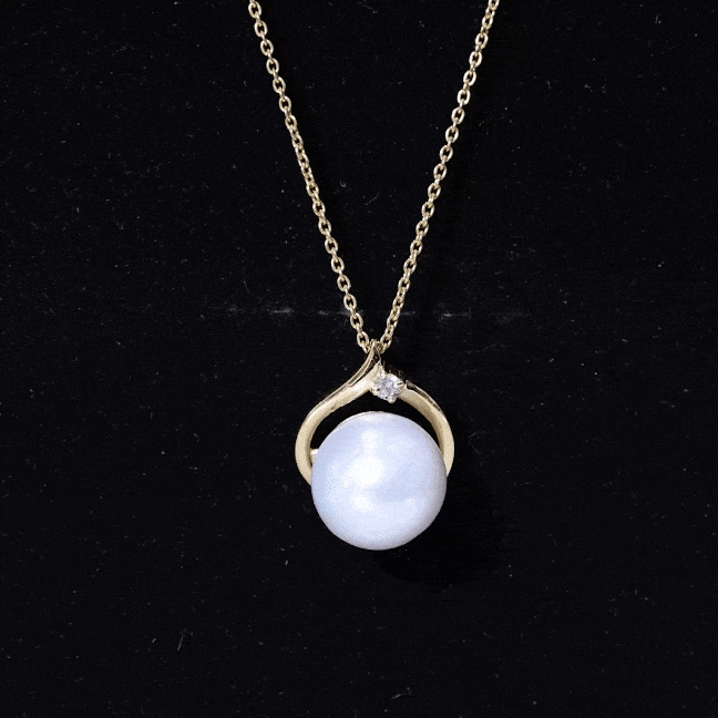 Yellow gold pendant featuring an 11-carat white pearl solitaire with diamond accents, from Rosec Jewels.