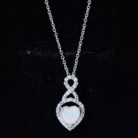 Heart-shaped Ethiopian opal infinity pendant with diamonds from Rosec Jewels, featuring vibrant yellow hues and intricate detailing.