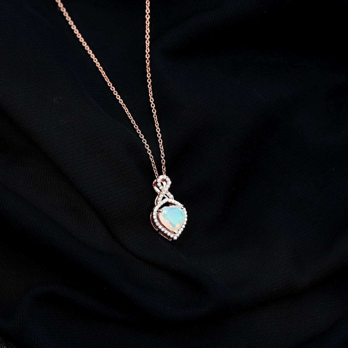 Heart-shaped Ethiopian opal infinity pendant with diamonds, featuring 2-carat opal and elegant design from Rosec Jewels.