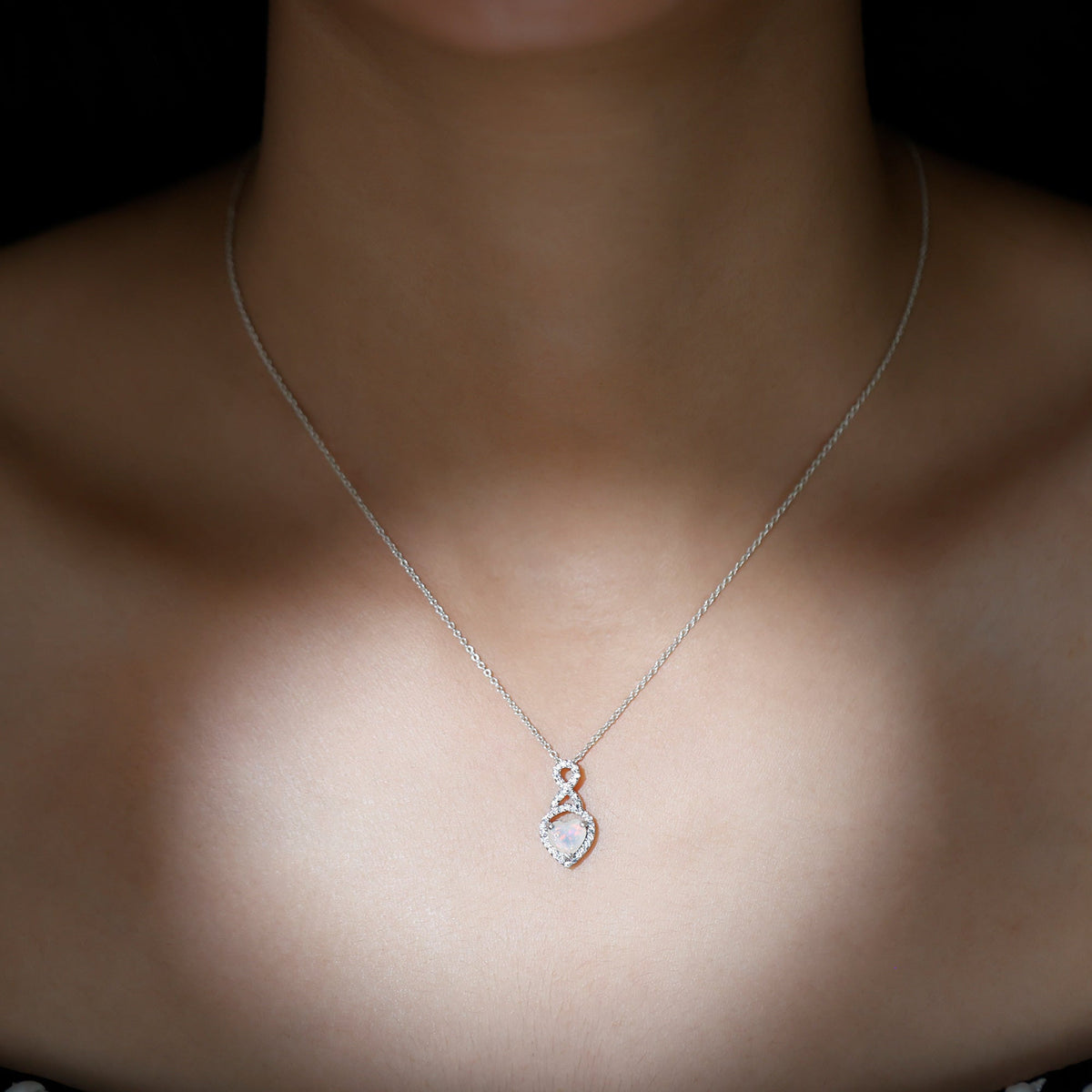 Heart-shaped Ethiopian opal infinity pendant with diamonds, showcasing a 2-carat gemstone and elegant design by Rosec Jewels.