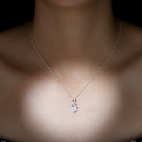 Heart-shaped Ethiopian opal infinity pendant with diamonds, showcasing a 2-carat gemstone and elegant design by Rosec Jewels.