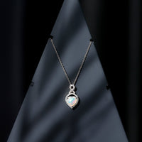 Heart-shaped Ethiopian opal infinity pendant with diamonds, featuring a 2-carat gemstone, crafted by Rosec Jewels.