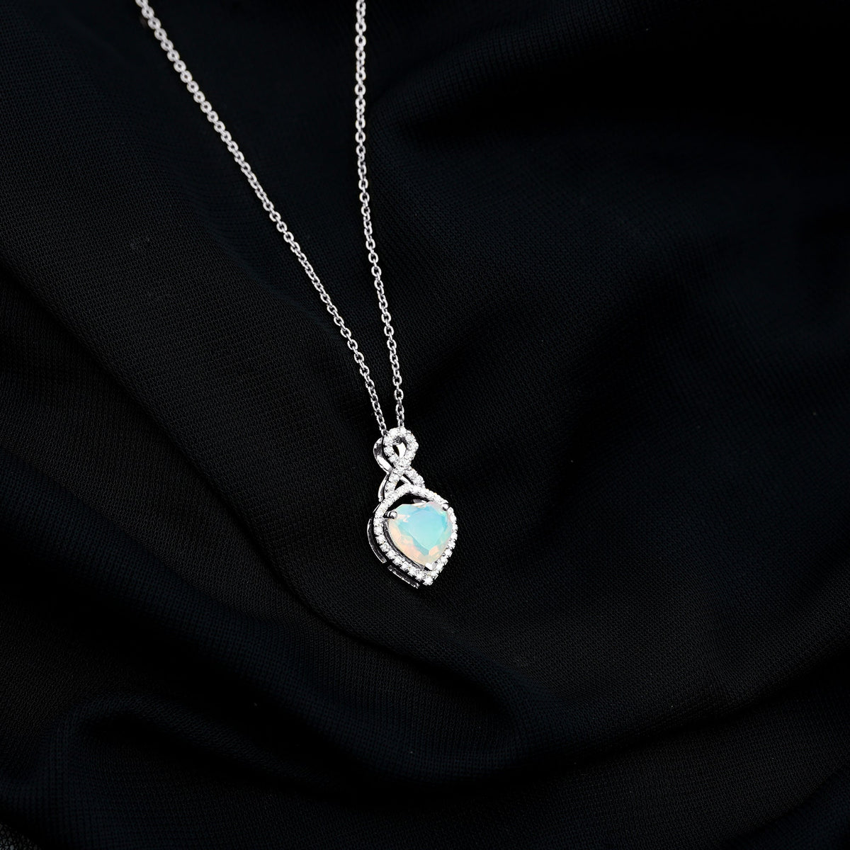 Heart-shaped Ethiopian opal infinity pendant with diamonds, featuring 2 carats of vibrant gemstones, by Rosec Jewels.