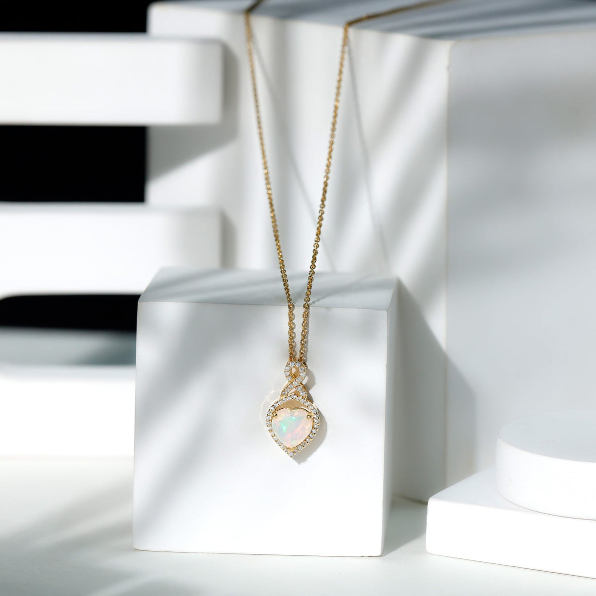 Heart-shaped Ethiopian opal infinity pendant with diamonds, featuring a 2-carat opal, by Rosec Jewels.