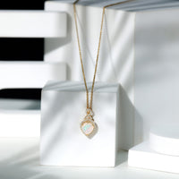 Heart-shaped Ethiopian opal infinity pendant with diamonds, featuring a 2-carat opal, by Rosec Jewels.