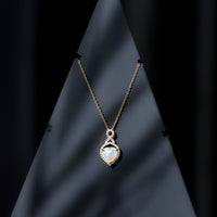 Heart-shaped Ethiopian opal infinity pendant with diamonds, featuring a 2-carat center stone, by Rosec Jewels.