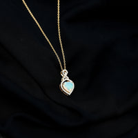 Heart-shaped Ethiopian opal infinity pendant with diamonds, featuring 2-carat opal and delicate chain from Rosec Jewels.