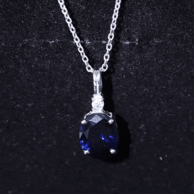 Oval cut 4 carat lab-grown blue sapphire pendant on silver chain, featuring a solitaire design by Rosec Jewels.