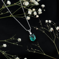 Oval Created Emerald and Moissanite Solitaire Pendant